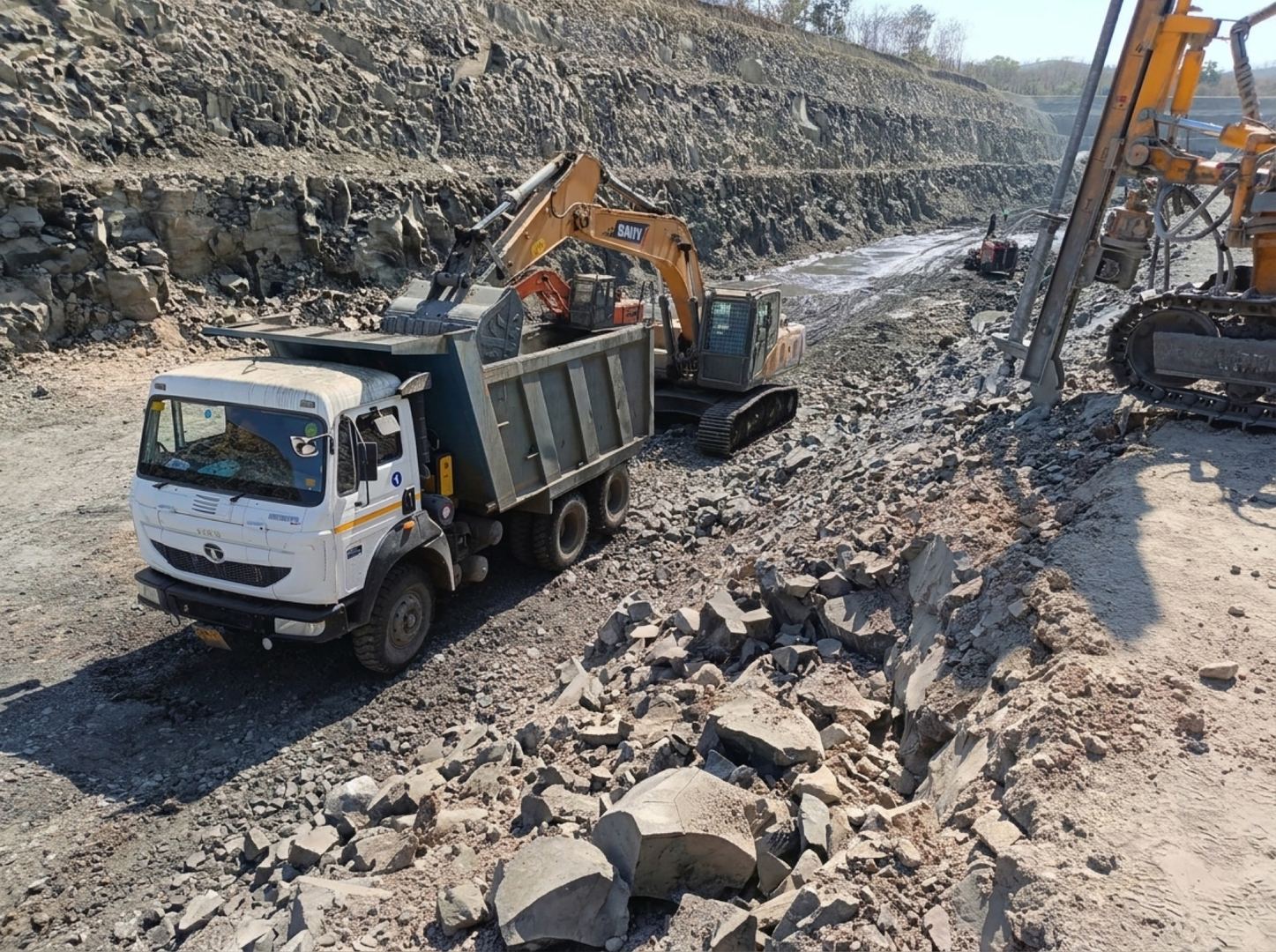 Excavator loading dump truck at railway construction site